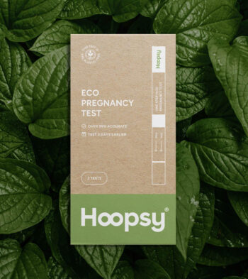 Hoopsy Eco-Friendly Pregnancy Test on a green leafy background