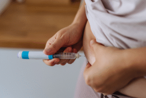 woman injecting IVF drugs to try and get pregnant