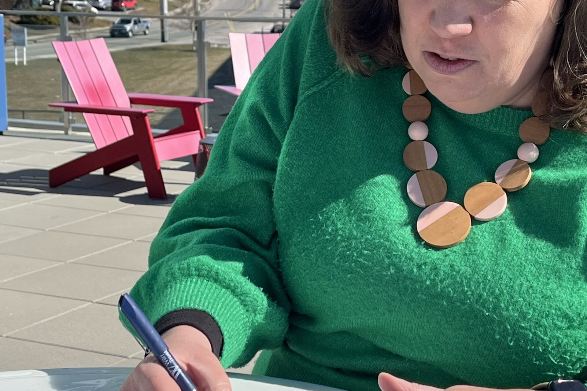 Lara writing the monthly fertility snail mail club letter