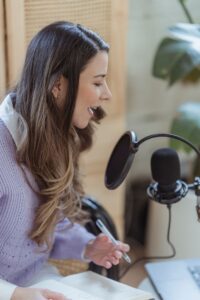 Woman speaking into a microphone for a Fertility Support TTC Podcast