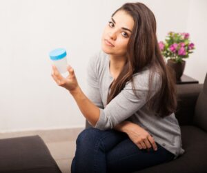 woman with specimen cup